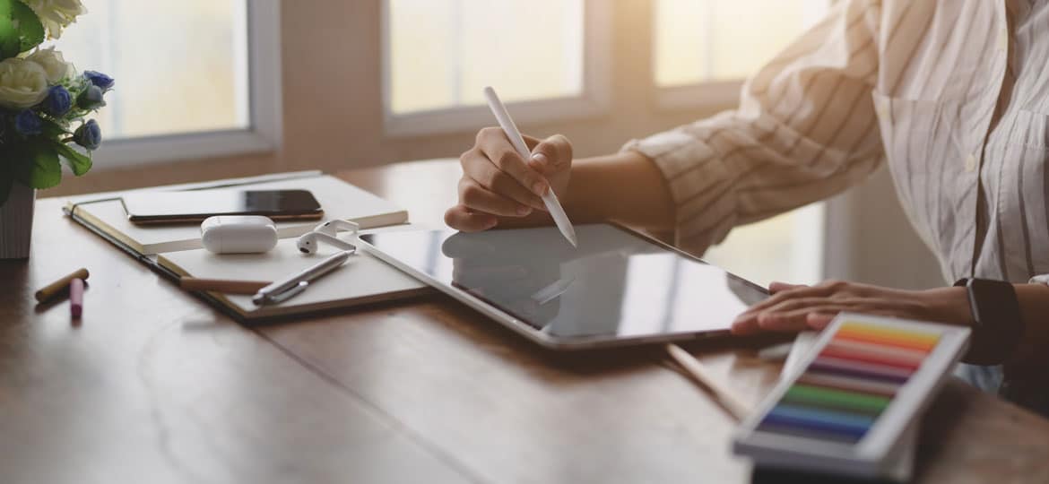 Graphic designer drawing a flat design logo on a tablet